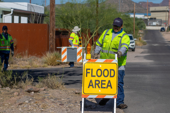 staff placing a flood area sign