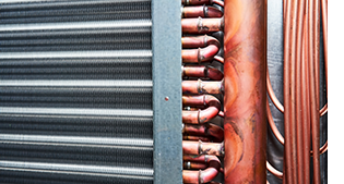 Copper coils inside an air conditioner.