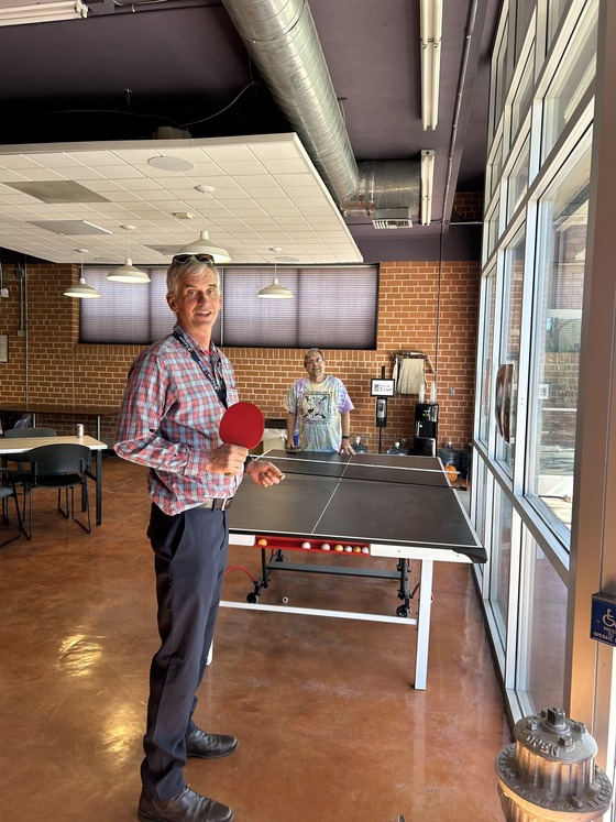 Photo of Vice Mayor Dahl teaching City Attorney Chris Avery (dressed in costume as a City Attorney) the finer points of Ping- Pong