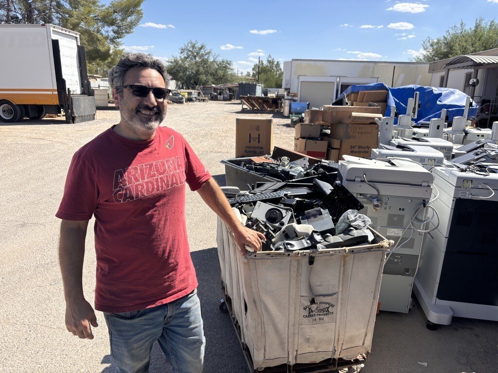 Photo of Eric Peterson with a cart of E-waste