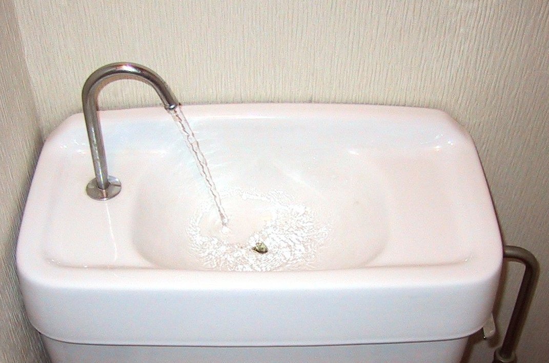 Photo of Water saving device on a Japanese toilet.