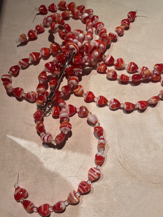 Photo of red glass beads that children receive for blood treatments.