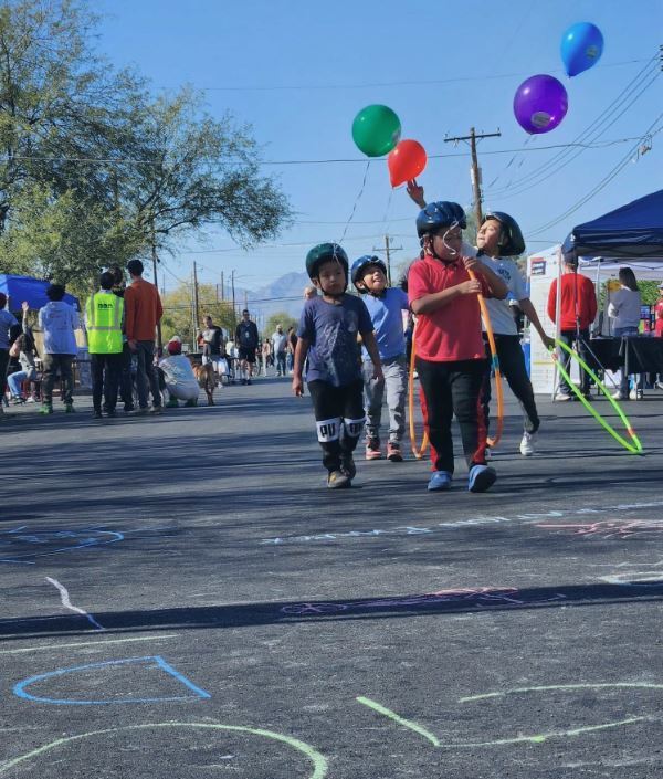 Picture of kids walking holding balloons and having fun