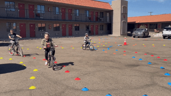 LSA's Safe Routes Manager Benji Rouse riding with the kids through the traffic garden.