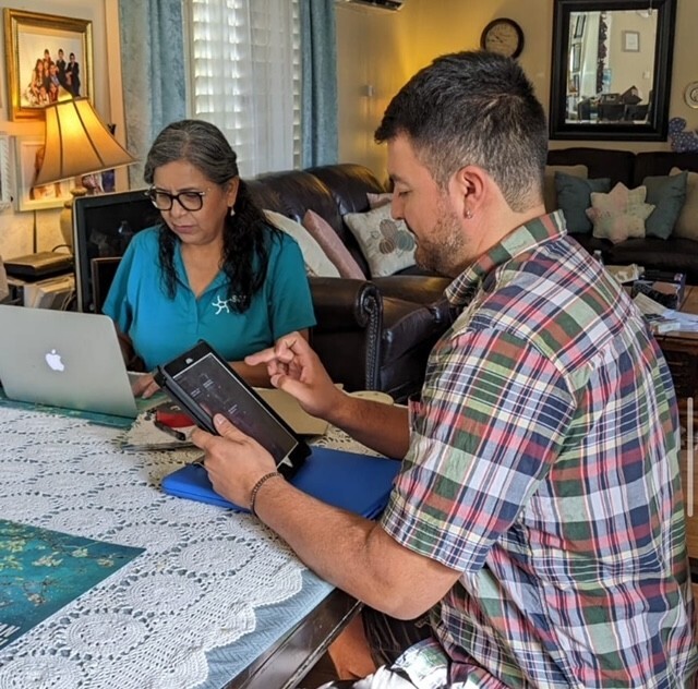 Palmira Henriquez going over program details with a homeowner.