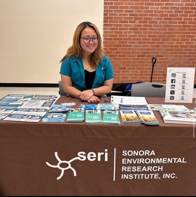 Photo of Jella Balgos -Community Outreach Specialist set up at a community event.