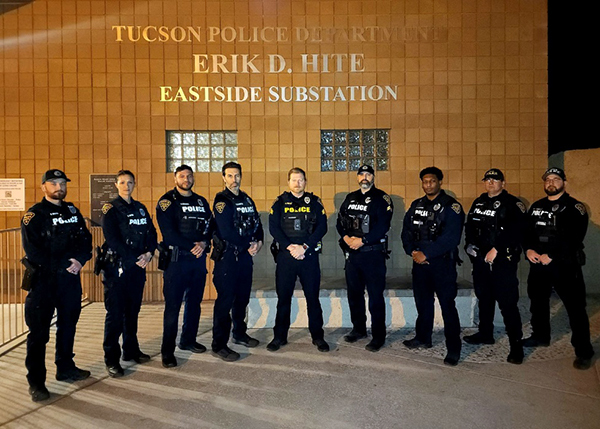 Group photo of TPD officers in uniform in front of a wall that says Erik D. Hite Eastside Substation.