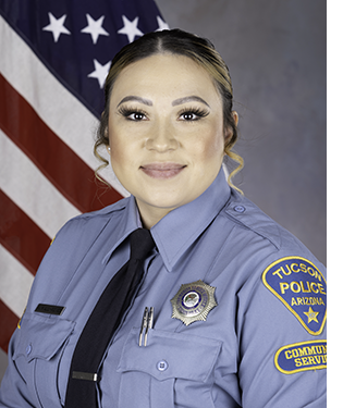Department photo of female TPD CSO in uniform in front of an American flag.