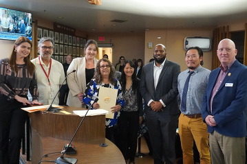 Staff pose for a photo during Tucson Mayor Regina Romero's 2024 Fair Housing Month Proclamation