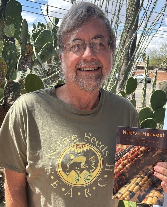 Photo of Council Member Dahl holding a copy of his Native Harvest book.