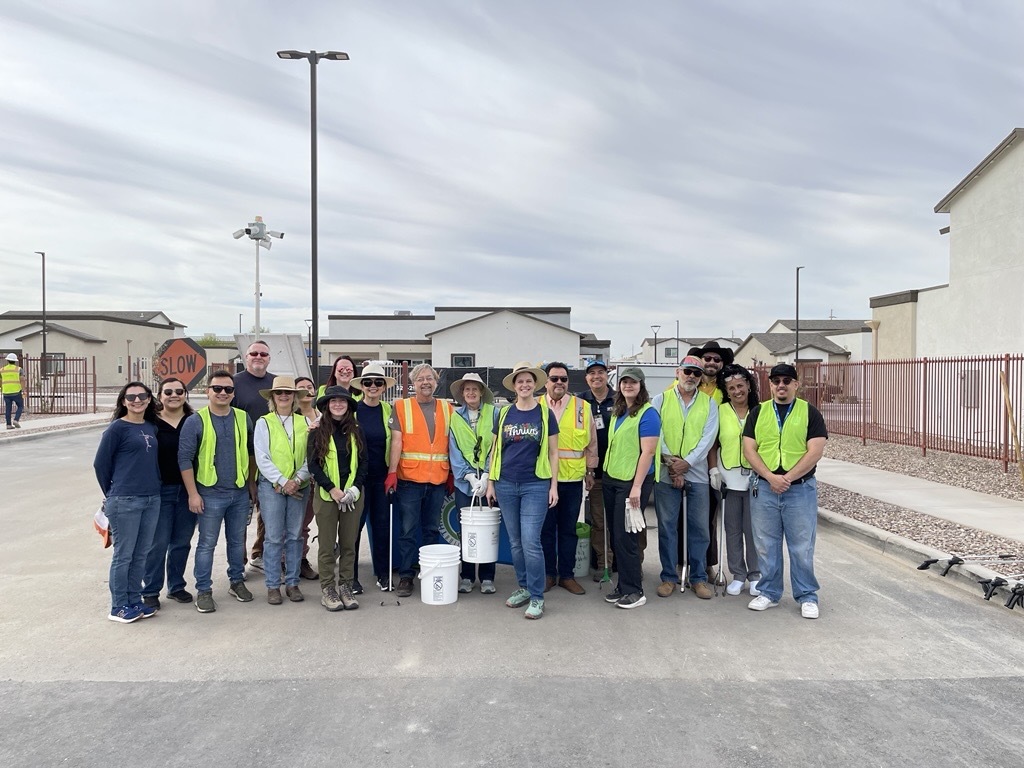 Photo of A group picture of the clean up participants in front of Sleepy Hollow Development. 