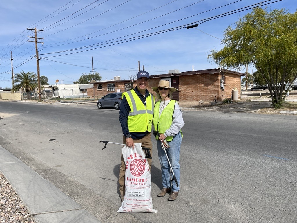 Photo of Libby Eshbaugh and Environmental Services’ Steven LaTurco with one of the bags filled with trash. 