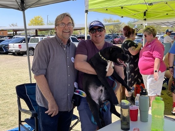 Photo of Council Member Kevin Dahl with Parks and Recreation Director Lara Hamwey carrying her sweet dog, Tater. 