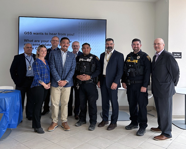 Group photo of officers and non-officers in an office setting.