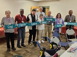 Council Member Fimbres poses with street signs
