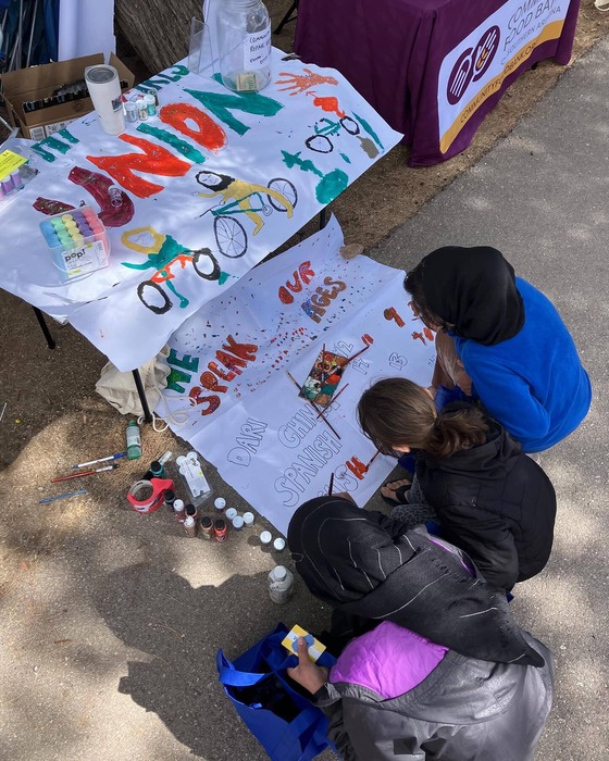 photo of kids painting a banner for the Amphi women and girls union