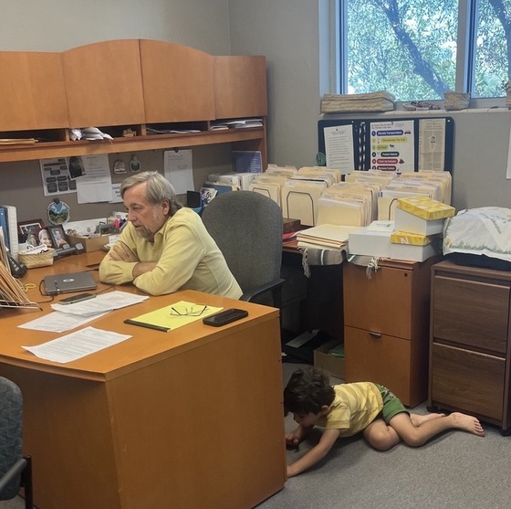 Photo of young boy playing in Kevin Dahl's office