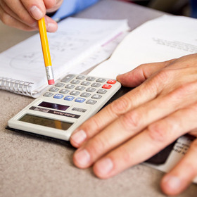 Hands using calculator