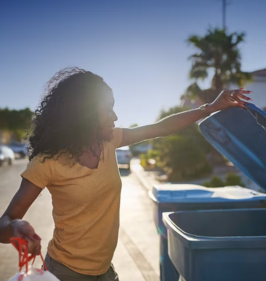 Person placing items in recycle container