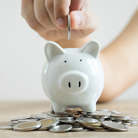 putting coins in piggybank