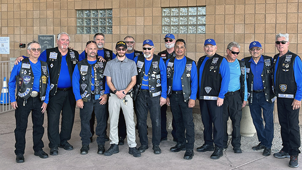 Group photo of men wearing blue shirts, taken at the Eastside Substation.