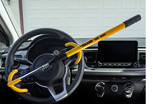 Yellow "club" steering wheel lock on a Kia steering wheel.