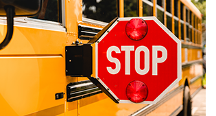 Close-up of school bus stop sign, sign extended.