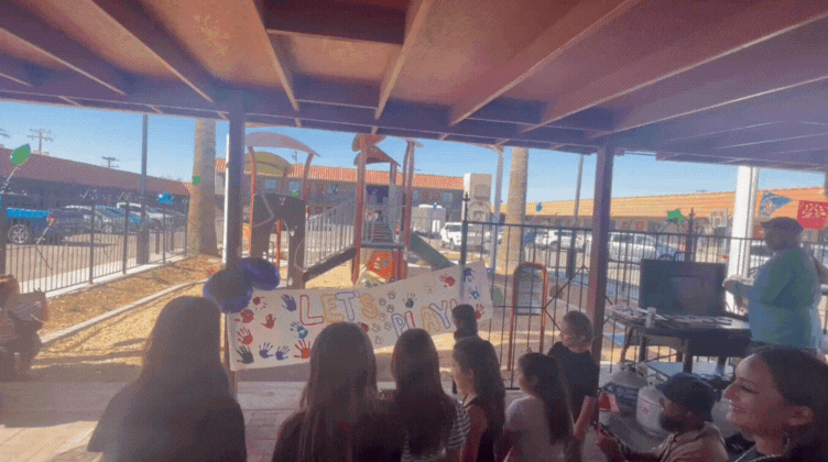 Gif of kids running through paper banner.