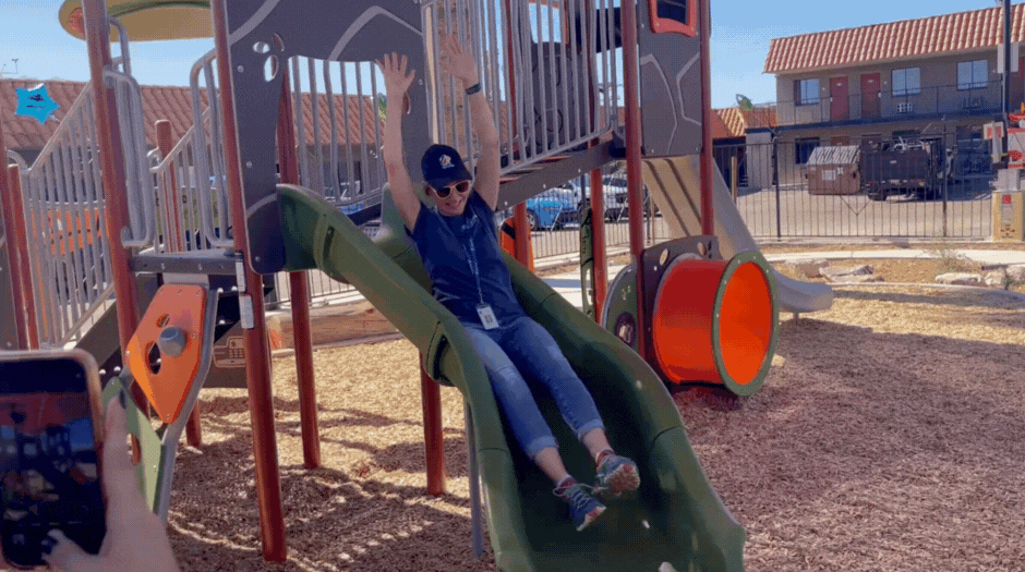 GIF of Anne Chaneka going down a slide.