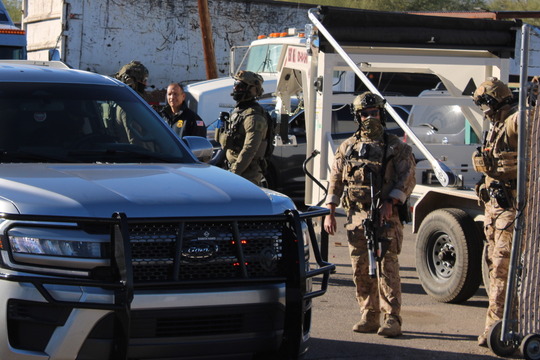 Photo of Heavily armed Federal agents escorting a government vehicle out of Noemi Trucking.