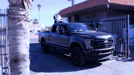 GIF of santa arriving in a pick up truck.