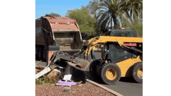 GIF of Garbage truck baing loaded with brush and bulky materials.