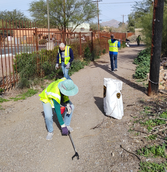 Photo of Dodge Flower residents cleaning alley.