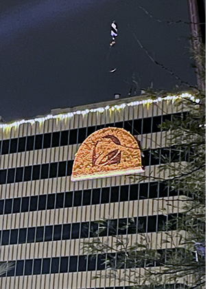 A huge Taco Bell taco is slowly lowered from the Transamerica Bldg. at night, similar to the disco ball drop in Times Square.
