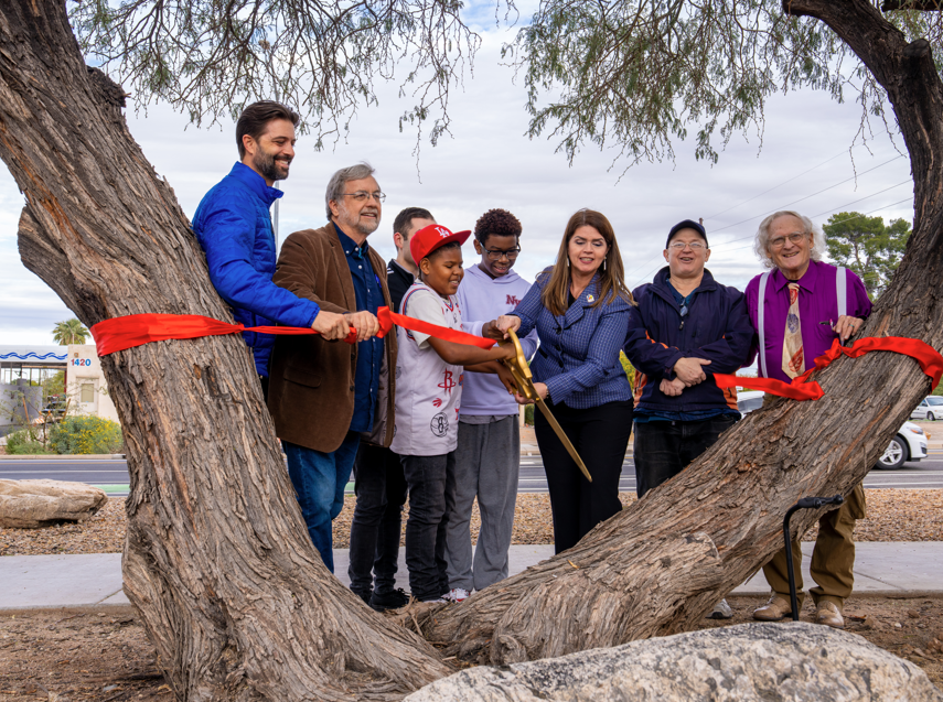Photo of Mayor Romero cutting the Roger Road ribbon.