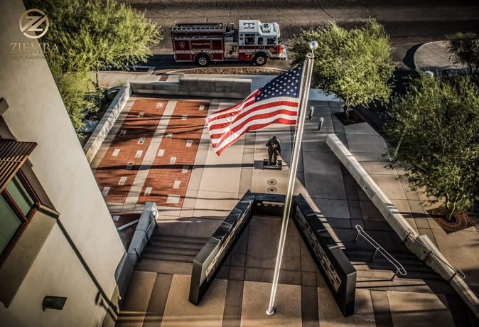 A view of an American flag flying over the Tucson Fallen Firefighters Memorial