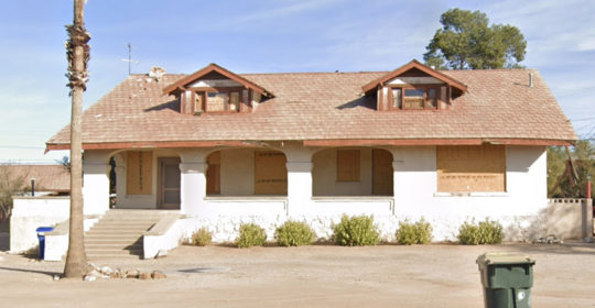 Photo of the house at 1177 E. Lester boarded up and empty.