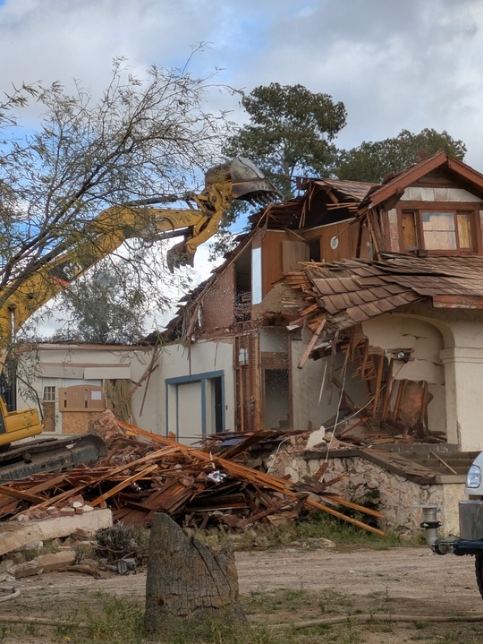 Photo of the house at 1177 E. Lester being demolished.