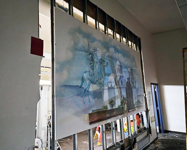 Mural of Father Kino and San Xavier Mission, with the surrounding wall chiseled away.