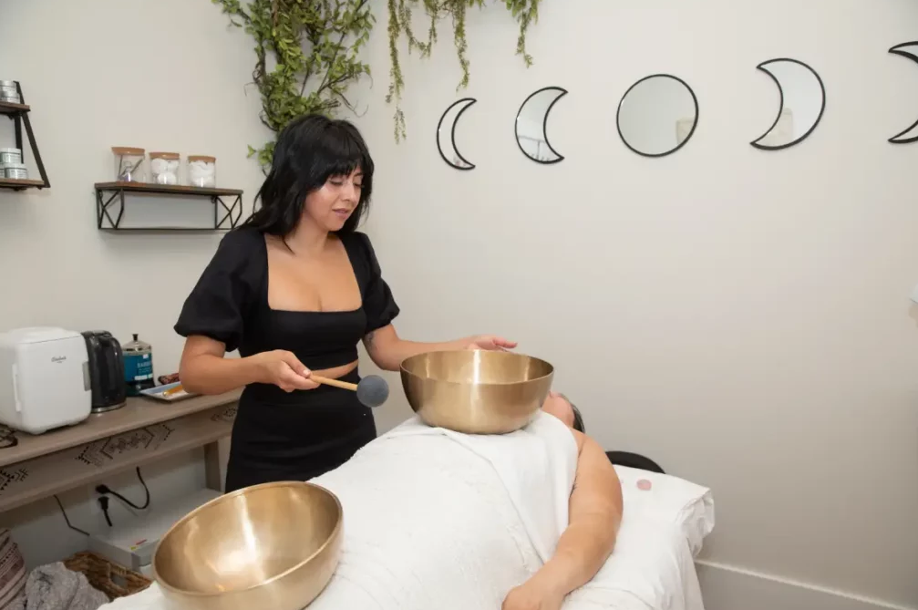 Photo of Adina Diaz working with a client. 