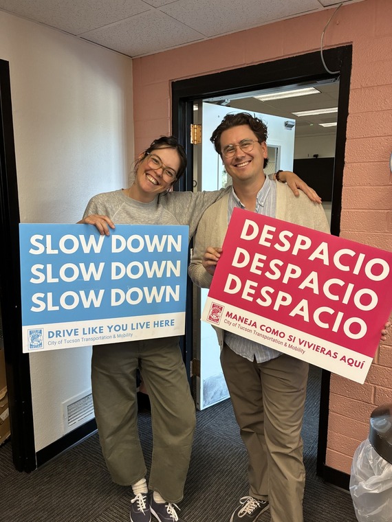 Ben and Marlene holding Slow Down Signs