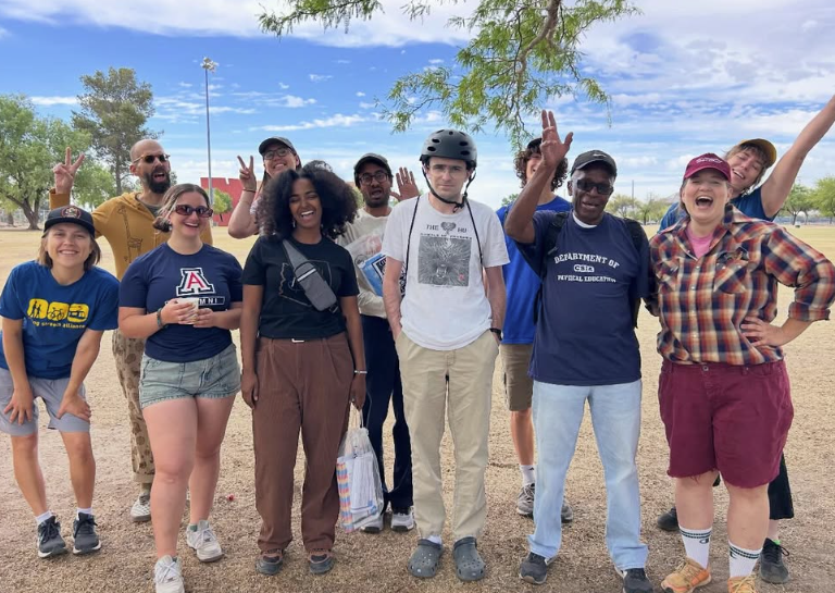 Photo of a group of volunteers celebrating after a neighborhood cleanup.