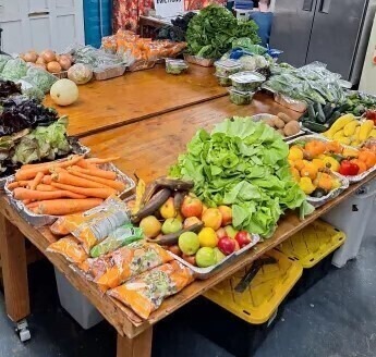 Photo of fruits and vegetables on display on a table.