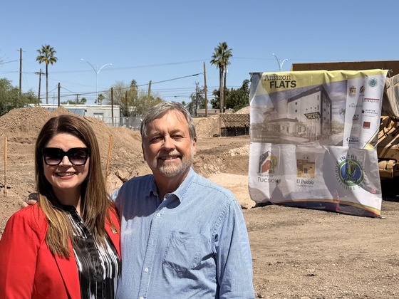 Photo of Mayor Romero with Council Member Dahl in front of the soon to be Amazon Flats.