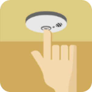 Imaage of hand pressing a smoke detector button.