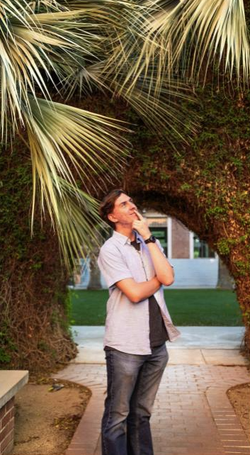 Photo of Ward 3 intern Payson standing at the University of Arizona looking up.