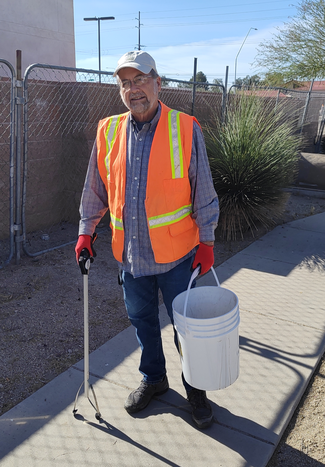 Photo of Council Member Kevin Dahl with a bucket , helping during the Earth Day community cleanup.
