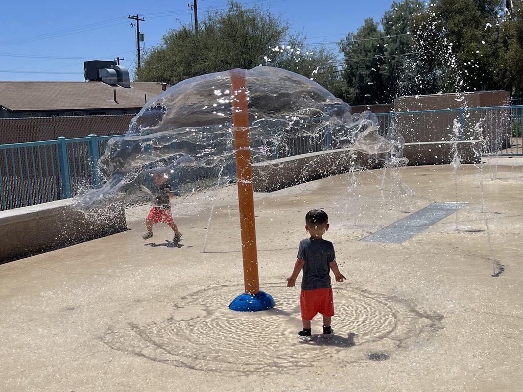 Photo of Two brothers enjoying the Nadia Jane Baker Splash Pad.
