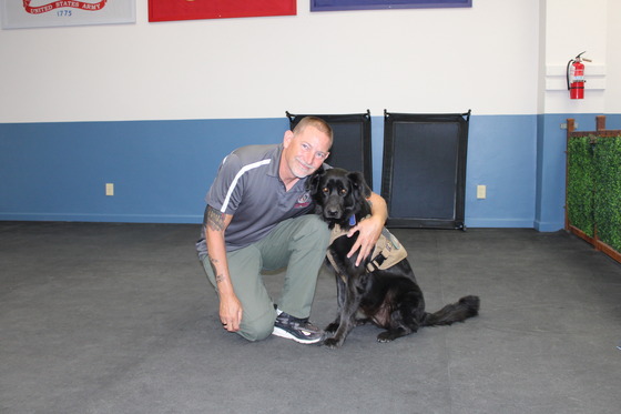 Photo of Mohammed Zantout and his black Labrador Trigger.