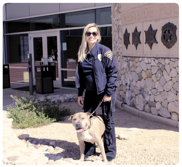 Photo of Police Captain Lauren Pettey with her dog Helo outside of the Miracle Mile police station.